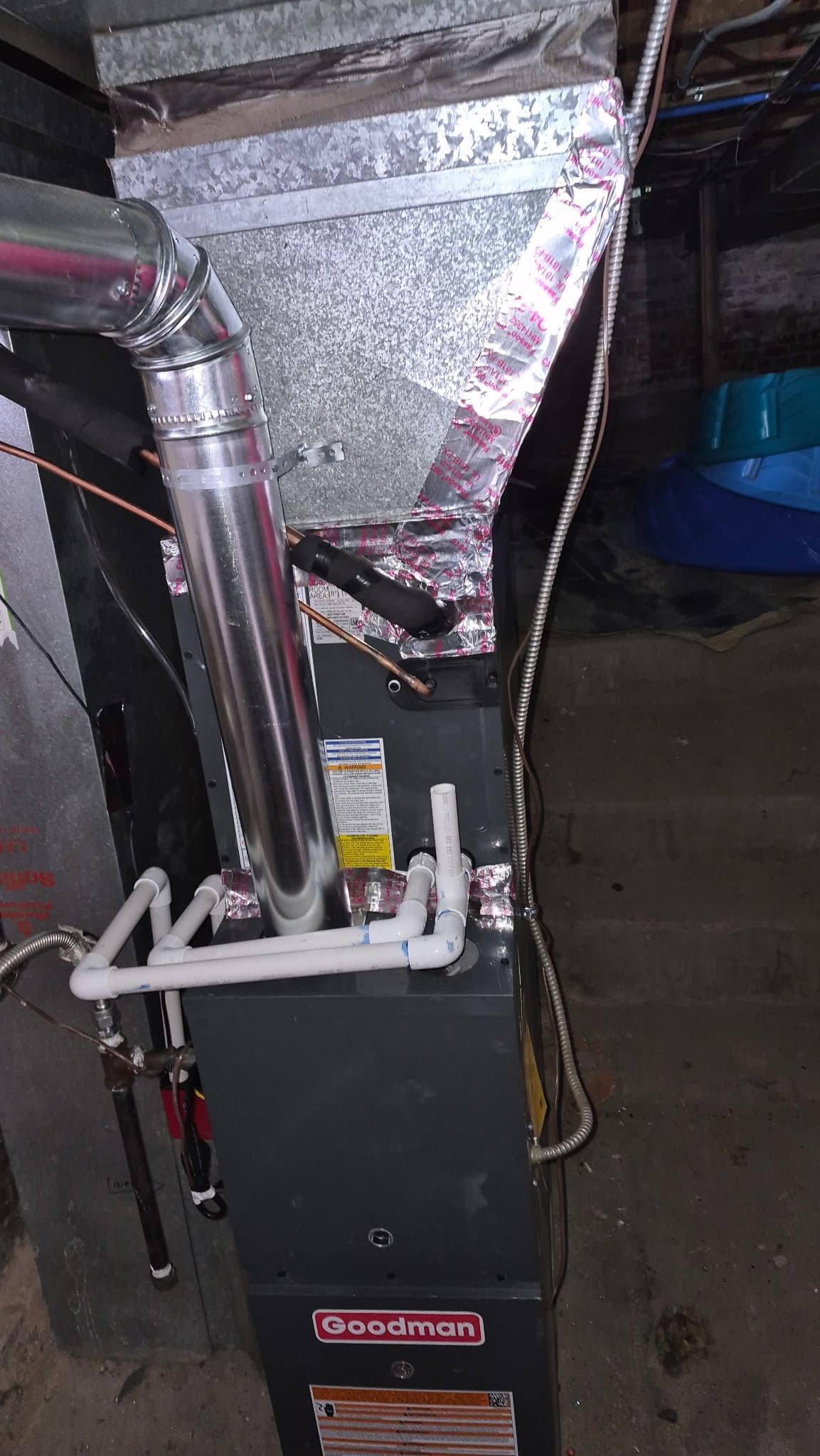 Goodman furnace installation with PVC flue pipes in Denver basement