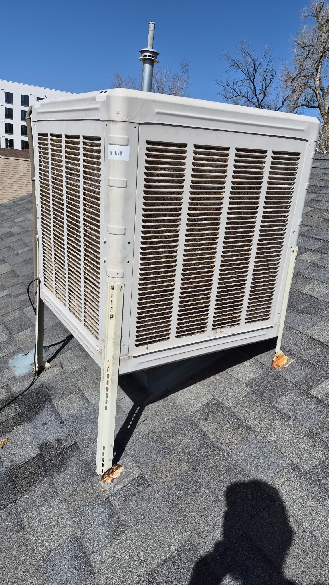 Whole-house rooftop evaporative cooler on Denver residential roof