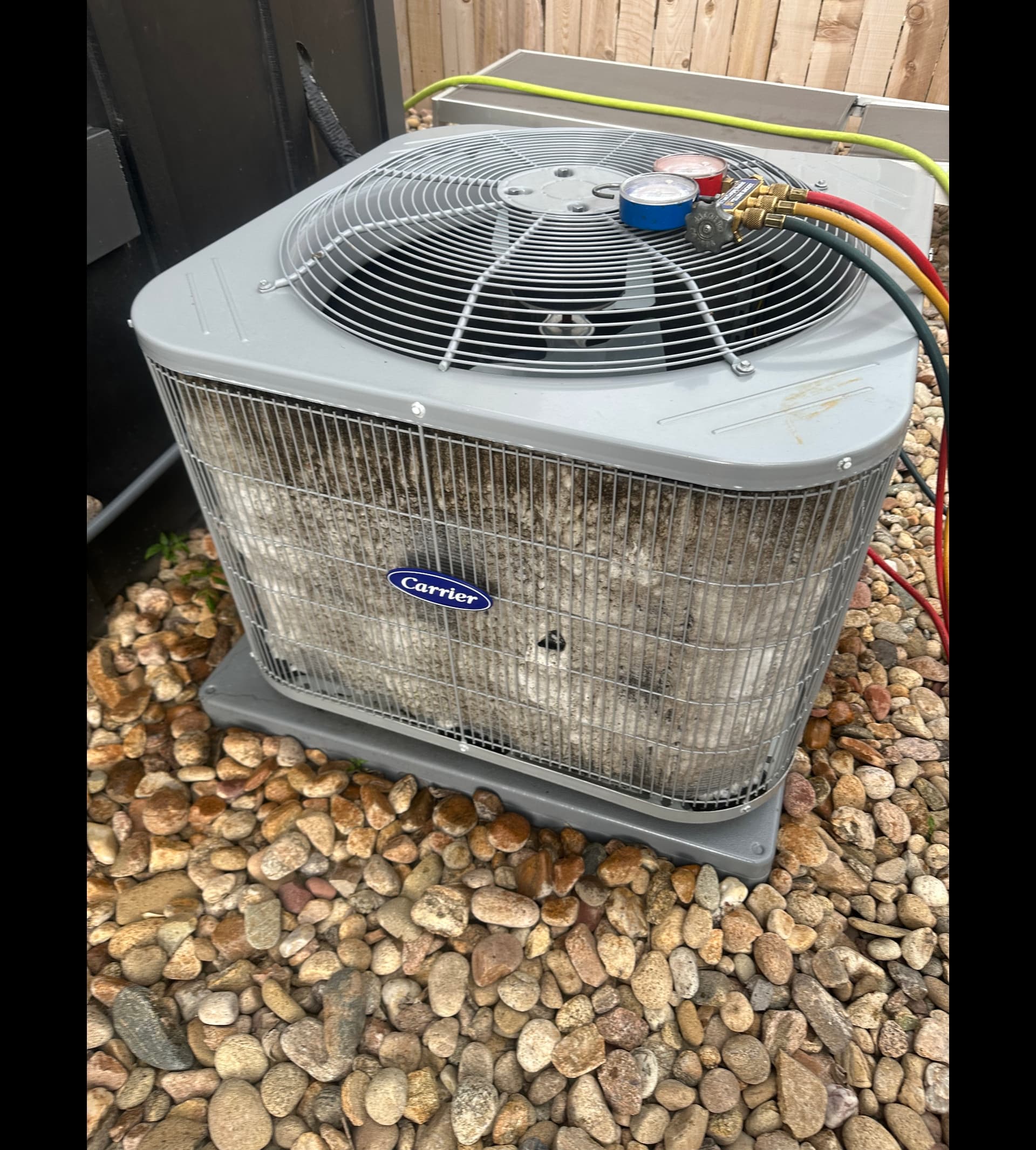 Carrier central AC unit with refrigerant manifold gauges attached