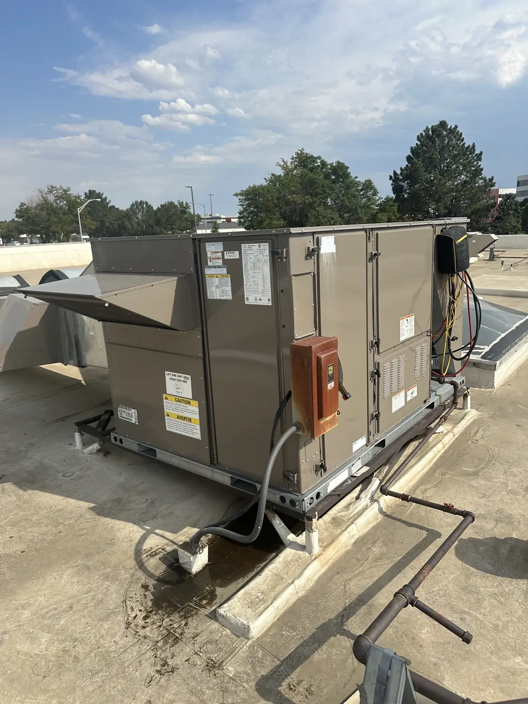 Commercial rooftop packaged HVAC unit on a Denver flat roof